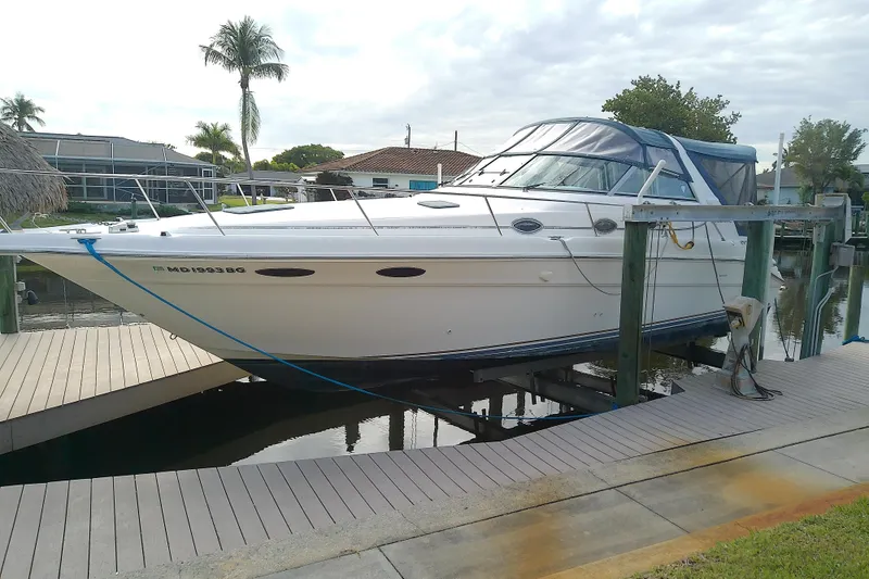 Slide: The Image of 1998 Sea Ray Sundancer 330 yacht docked, featuring sleek design and white exterior. - 3