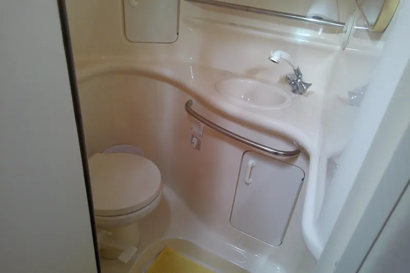 Slide: The Image of Bathroom interior of 1998 Sea Ray Sundancer 330 yacht, featuring sink and toilet. - 35