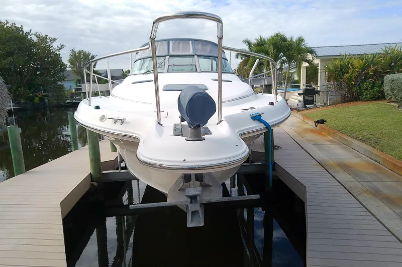 Slide: The Image of 1998 Sea Ray Sundancer 330 yacht docked, showcasing sleek design and waterfront setting. - 4