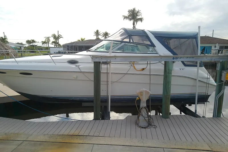 Slide: The Image of 1998 Sea Ray Sundancer 330 yacht docked, featuring sleek design and spacious cabin. - 45