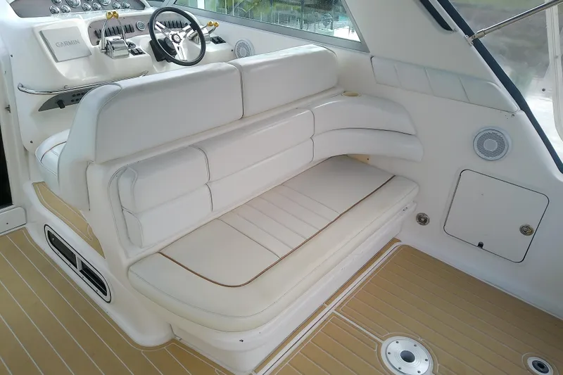 Slide: The Image of Interior of 1998 Sea Ray Sundancer 330 with white seating and helm controls. - 9