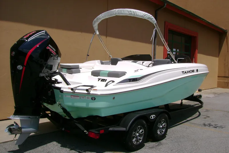 Slide: The Image of 2026 Tahoe T21 boat on trailer, featuring sleek design and powerful outboard motor. - 2