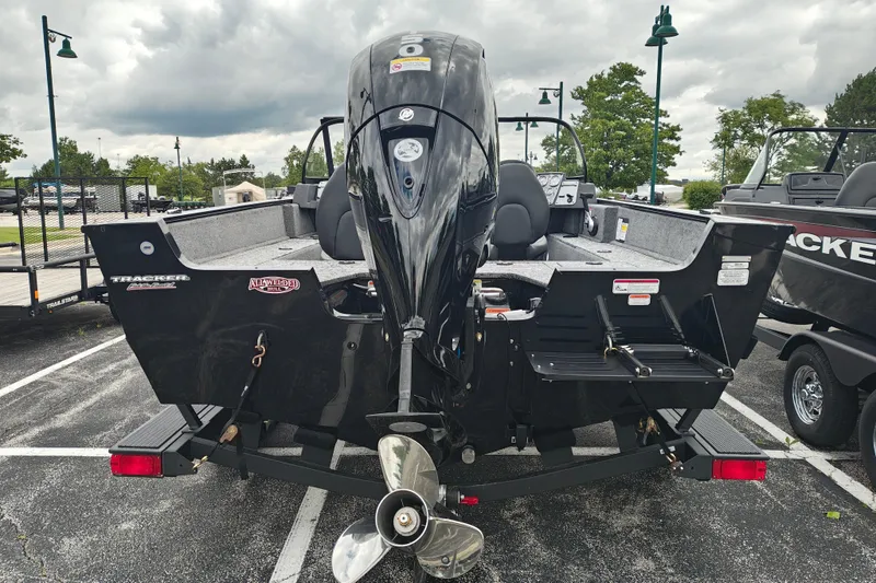 Slide: The Image of 2026 Tracker Pro Guide V-175 WT boat with powerful outboard motor in parking lot. - 2