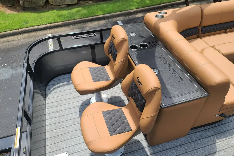 Slide: The Image of Luxurious seating on 2026 Ranger 223FC boat with tan upholstery and cup holders. - 7
