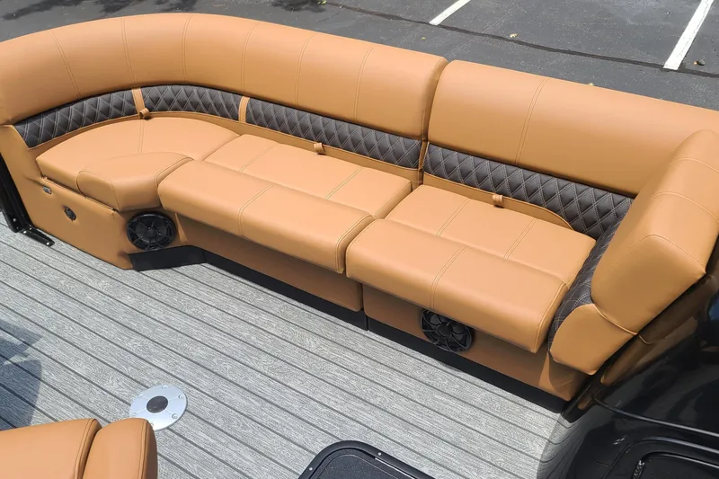 Slide: The Image of Luxurious tan seating on 2026 Ranger 223FC boat, featuring diamond-patterned accents and integrated speakers. - 10