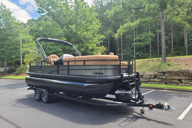 Slide: The Image of 2026 Ranger 223FC pontoon boat on trailer in a scenic parking lot. - 5