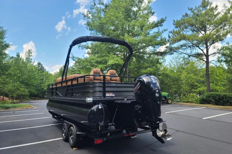 Slide: The Image of 2026 Ranger 223FC boat on trailer in scenic parking lot. - 1