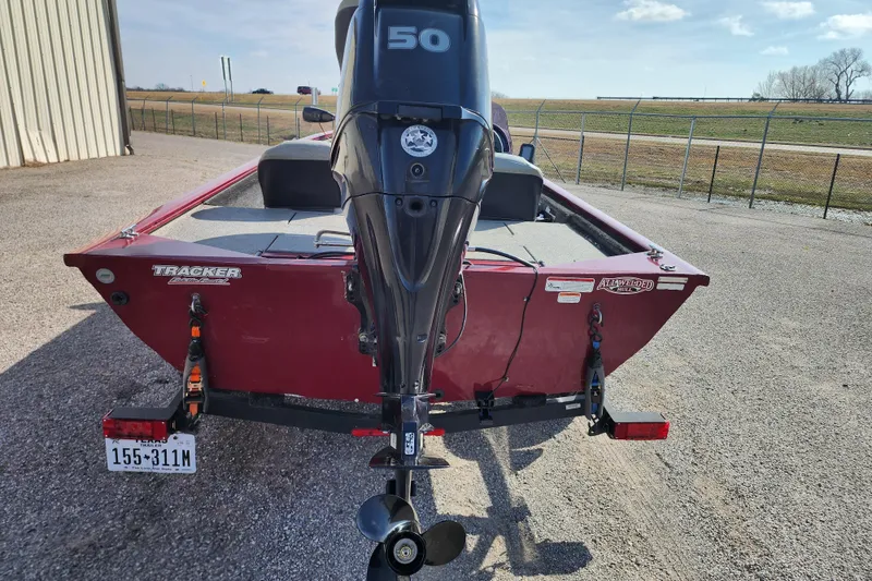 Slide: The Image of 2026 Tracker Pro 170 boat with 50 HP motor, parked outdoors. - 63