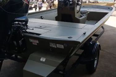 Slide: The Image of 2026 Tracker Grizzly 1860 CC boat, rear view, parked on trailer. - 2