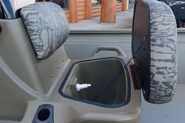 Slide: The Image of 2026 Tracker Grizzly 1860 CC boat interior with open storage compartment. - 8