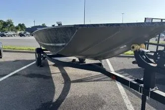 Slide: The Image of 2026 Tracker Grizzly 1648 Utility boat on trailer in parking lot. - 2