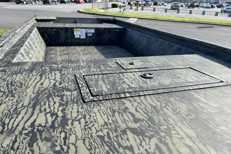 Slide: The Image of 2026 Tracker Grizzly 1648 Utility boat with camouflage pattern in a parking lot. - 3