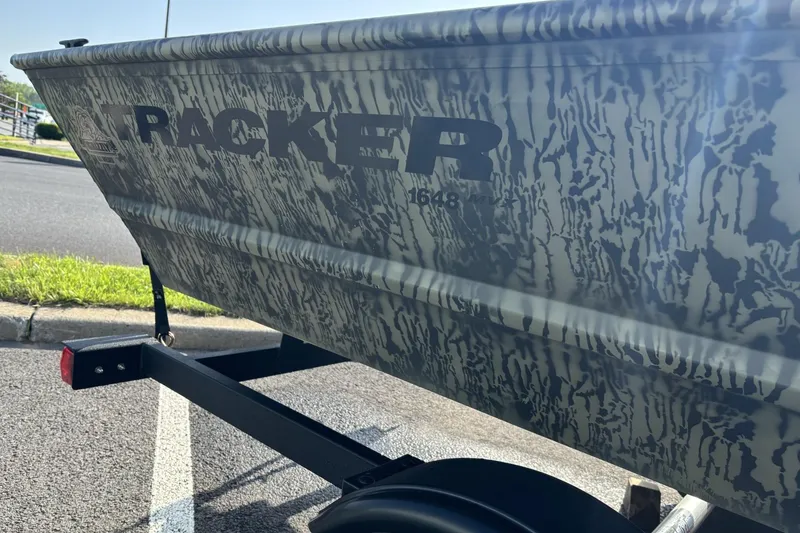 Slide: The Image of 2026 Tracker Grizzly 1648 Utility boat with camouflage pattern on a trailer. - 4