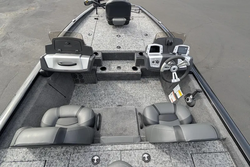 Slide: The Image of 2026 Tracker Pro Team 195 boat interior with steering wheel and seating. - 10