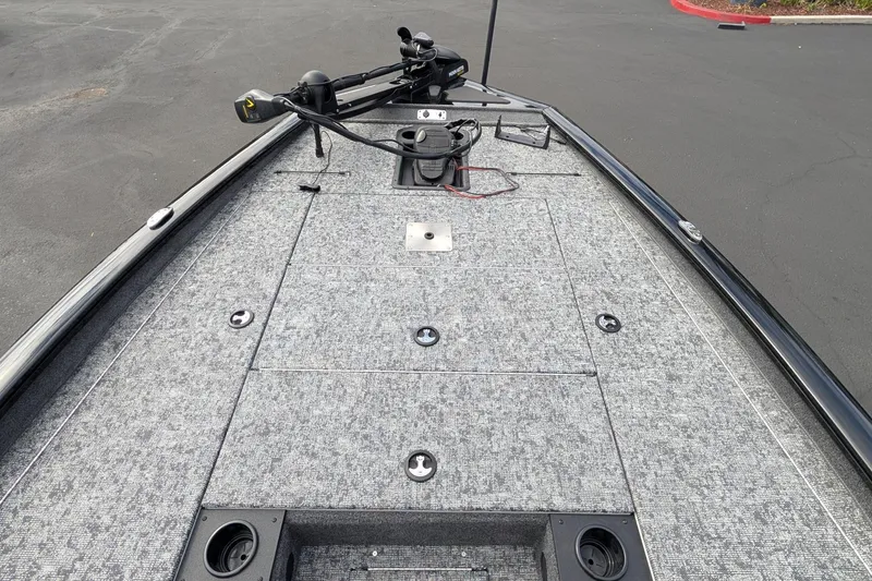 Slide: The Image of Front deck of a 2026 Tracker Pro Team 195 boat with fishing equipment. - 5
