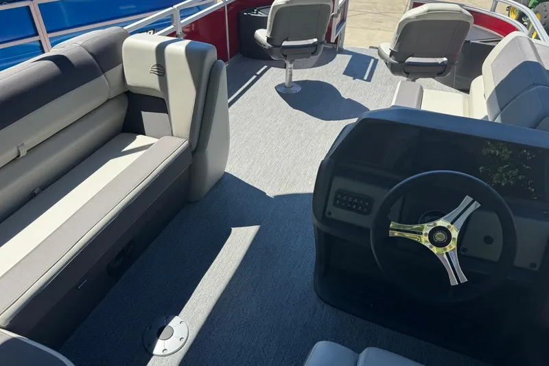 Slide: The Image of Interior of 2026 Sun Tracker Fishin' Barge 22 DLX pontoon boat with seating and steering wheel. - 12