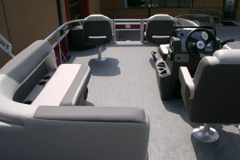 Slide: The Image of 2026 Sun Tracker Bass Buggy 18 DLX interior with seating and steering console. - 8