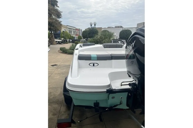 Slide: The Image of 2026 Tahoe T16 boat with Mercury engine, parked outdoors on a trailer. - 4