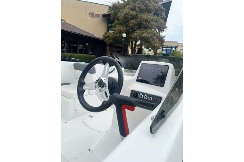 Slide: The Image of 2026 Tahoe T16 boat dashboard with steering wheel and control panel. - 7
