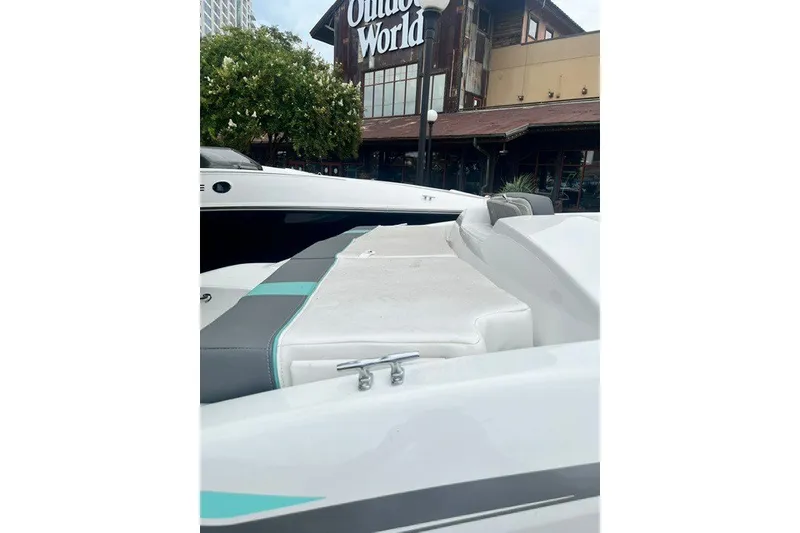 Slide: The Image of 2026 Tahoe T16 boat displayed outside a store, showcasing sleek design and seating. - 6