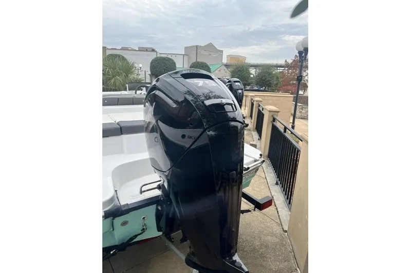 Slide: The Image of 2026 Tahoe T16 boat with Mercury outboard motor, parked outdoors. - 5