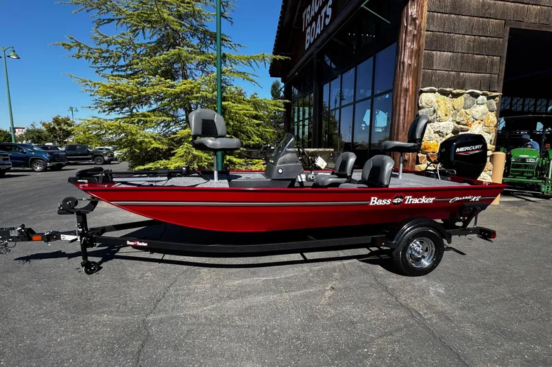 The Image of 2026 Tracker Bass Tracker Classic XL boat in vibrant red, parked outside a dealership. - 0