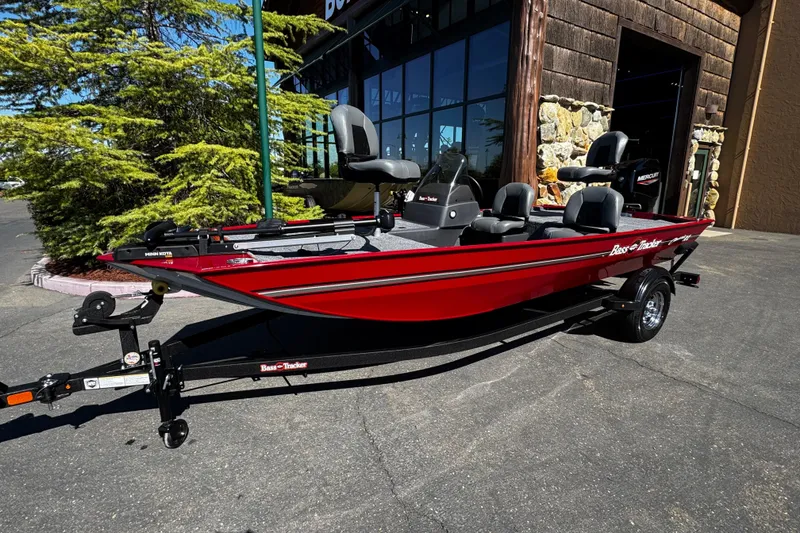 Slide: The Image of 2026 Tracker Bass Tracker Classic XL boat in vibrant red, parked outdoors. - 4