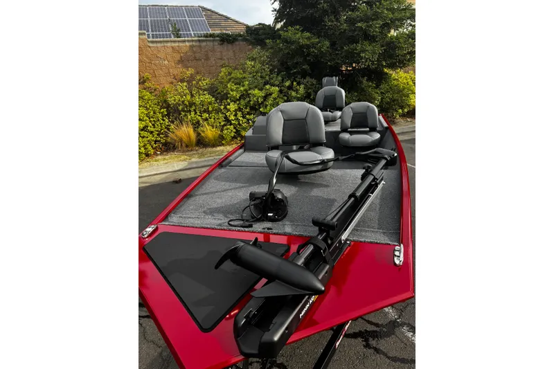 Slide: The Image of 2026 Tracker Bass Tracker Classic XL boat with seating and trolling motor, parked outdoors. - 5