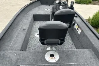 Slide: The Image of 2026 Tracker Super Guide V-16 SC boat interior with seating and steering console. - 51