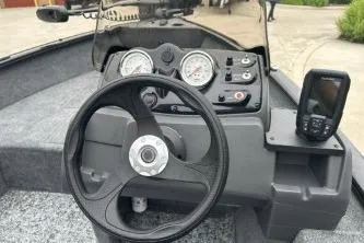 Slide: The Image of Steering console of 2026 Tracker Super Guide V-16 SC boat with gauges and navigation system. - 6