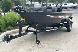 Slide: The Image of 2026 Tracker Super Guide V-16 SC boat on trailer, parked outdoors. - 2