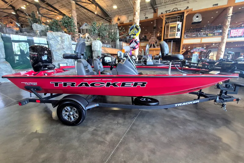 The Image of 2026 Tracker Pro Team 175 boat in showroom, red exterior, on trailer. - 0