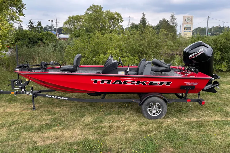 The Image of 2026 Tracker Pro Team 175 boat in vibrant red on a grassy area. - 0