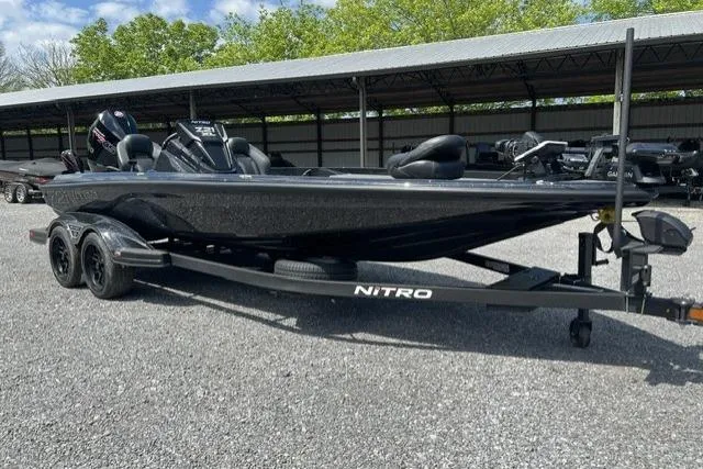 Slide: The Image of 2026 Nitro Z21 XL Pro boat on trailer, parked outdoors under a canopy. - 107