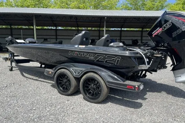 Slide: The Image of 2026 Nitro Z21 XL Pro boat with dual axle trailer, parked outdoors. - 110