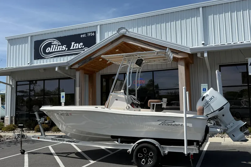 The Image of 2022 Pioneer 180 Sportfish boat on trailer outside Collins Inc. dealership. - 1