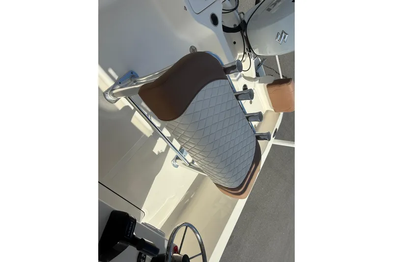 Slide: The Image of 2022 Pioneer 180 Sportfish boat seat with rod holders and steering wheel. - 7