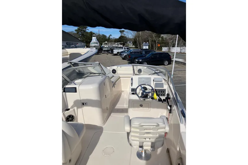 Slide: The Image of 2019 Grady-White Freedom 215 boat interior with steering wheel and seating. - 10