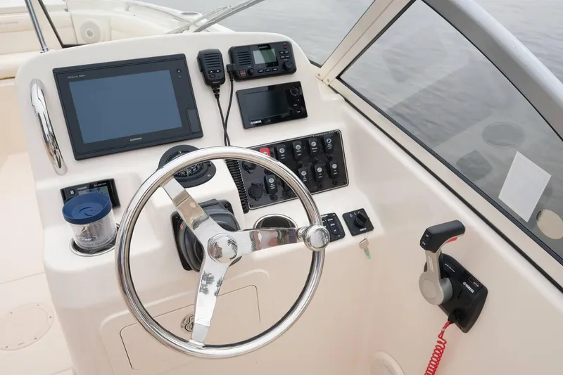 Slide: The Image of Manufacturer Provided Image: 2019 Grady-White Freedom 215 boat dashboard with steering wheel and electronic controls. - 20