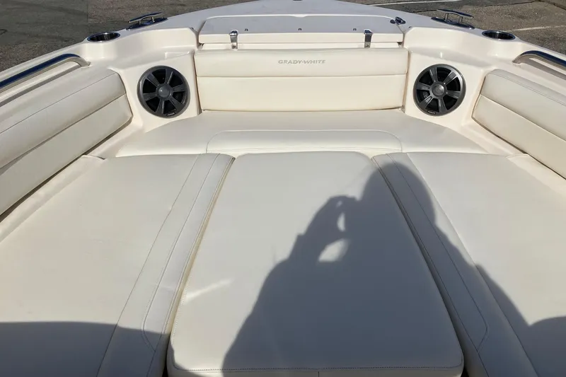 Slide: The Image of 2019 Grady-White Freedom 215 boat interior with cushioned seating and built-in speakers. - 5