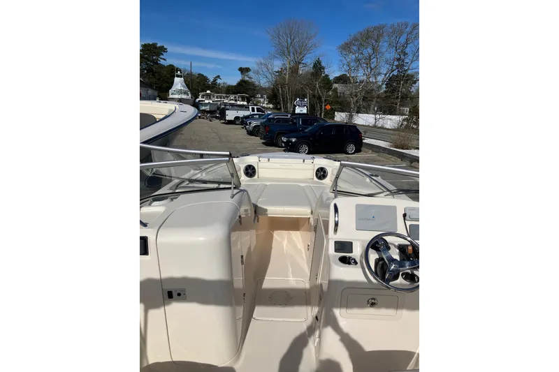 Slide: The Image of 2019 Grady-White Freedom 215 boat interior with steering wheel and dashboard, parked outdoors. - 8