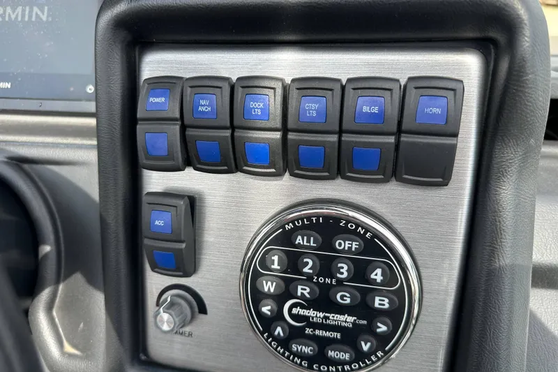 Slide: The Image of Control panel of 2024 Veranda VP25RCT boat with various switches and lighting controller. - 16