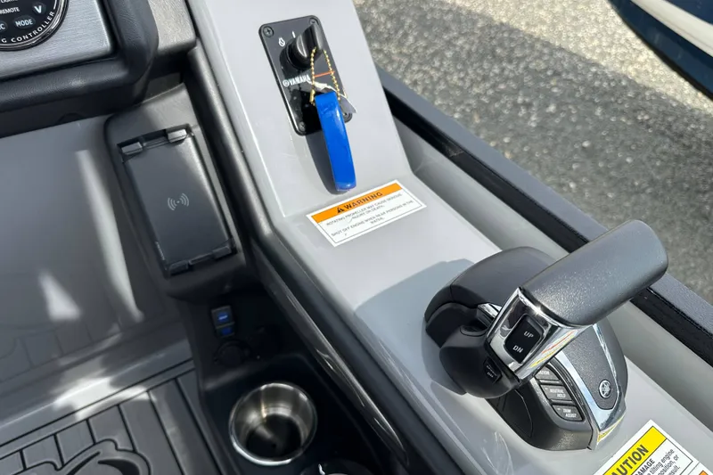 Slide: The Image of 2024 Veranda VP25RCT boat control panel with throttle, ignition, and cup holder. - 17