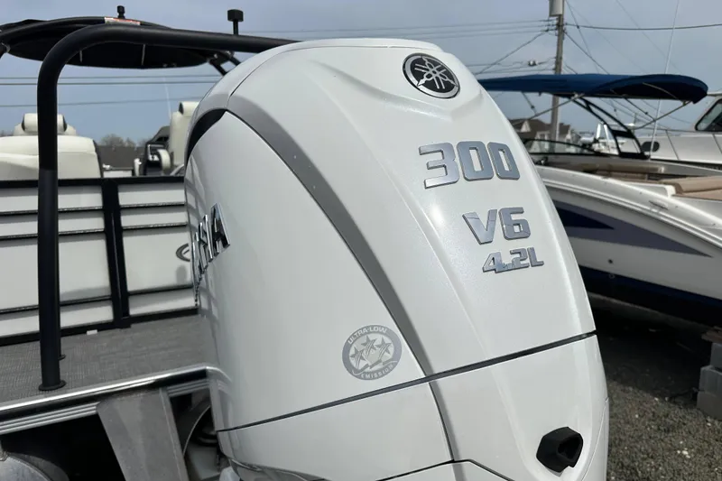 Slide: The Image of 2024 Veranda VP25RCT with Yamaha 300 V6 4.2L outboard engine, docked outdoors. - 2