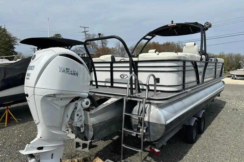 Slide: The Image of 2024 Veranda VP25RCT pontoon boat with Yamaha V6 engine, parked on a trailer. - 24