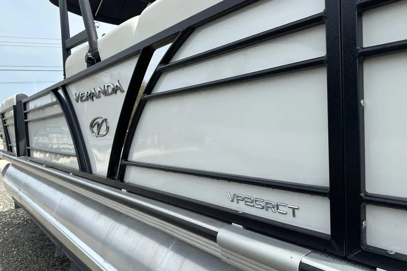 Slide: The Image of 2024 Veranda VP25RCT pontoon boat, sleek design with black and white detailing. - 3