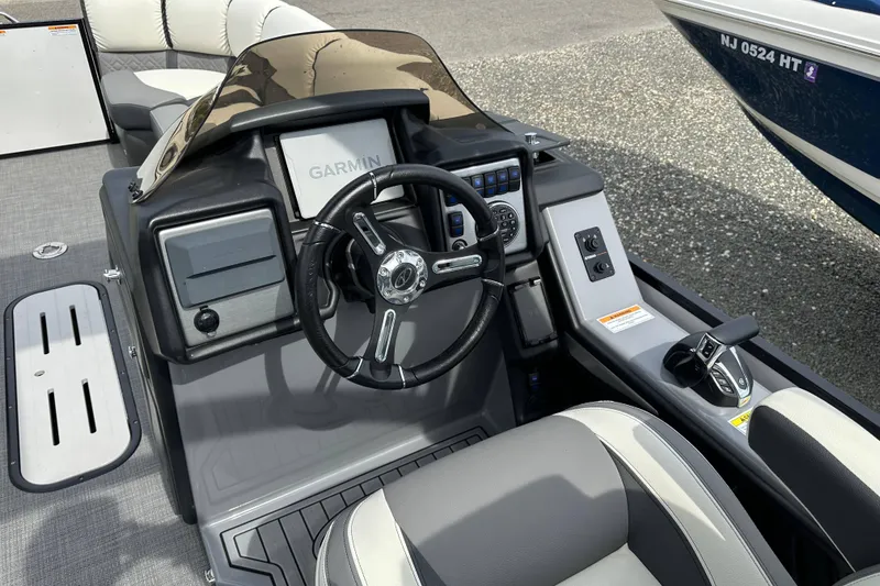 Slide: The Image of 2024 Veranda VP25RCT boat cockpit with Garmin navigation and modern steering controls. - 7