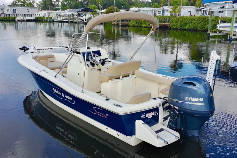 Slide: The Image of 2024 Scout 195 Sportfish boat with Yamaha engine on calm water. - 10