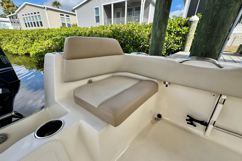 Slide: The Image of 2024 Scout 195 Sportfish boat interior with beige seating and cup holder. - 14