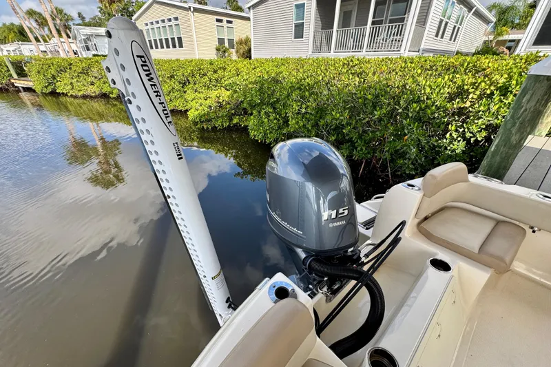Slide: The Image of 2024 Scout 195 Sportfish boat with Yamaha 115 engine and Power-Pole anchor in a scenic canal. - 16